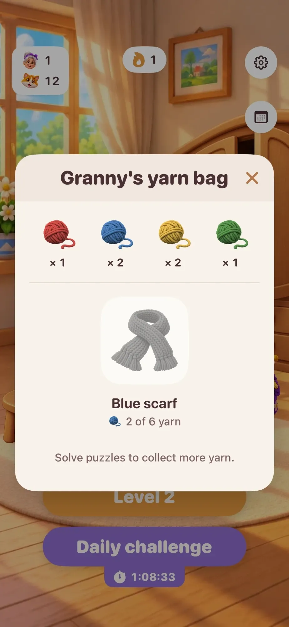 Granny's yarn bag with red, blue, yellow and green yarn, and a blue scarf with 2 of 6 yarn collected.